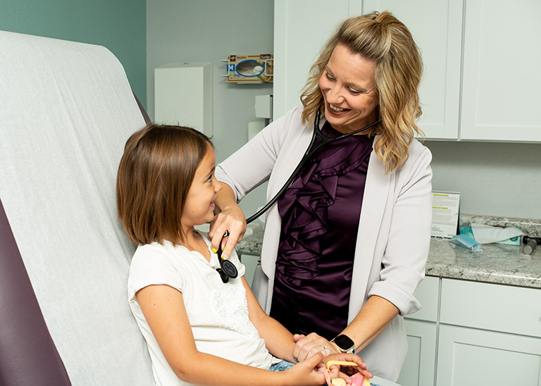 Nurse practitioner with a child patient