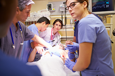 Clinicians caring for a patient in an emergency room