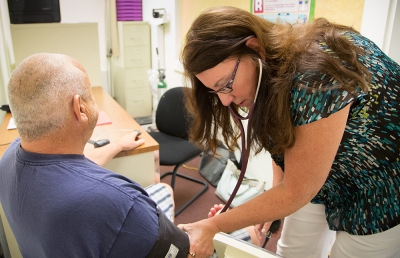 PhD student Julie Slack takes vital signs for Dr. Larson's research