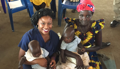 Faculty abroad with a mother and children