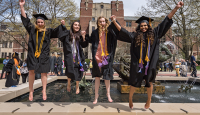Students jumping in celebration at Graduation