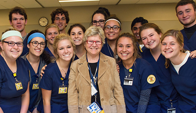 Donor surrounded by students
