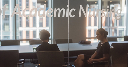 U-M School of Nursing Dean Patricia D. Hurn talk to Suzanne Miyamoto in a conference room