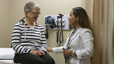 Student practices examination with volunteer patient 