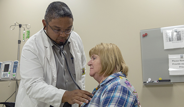 Student practices examination with volunteer patient 