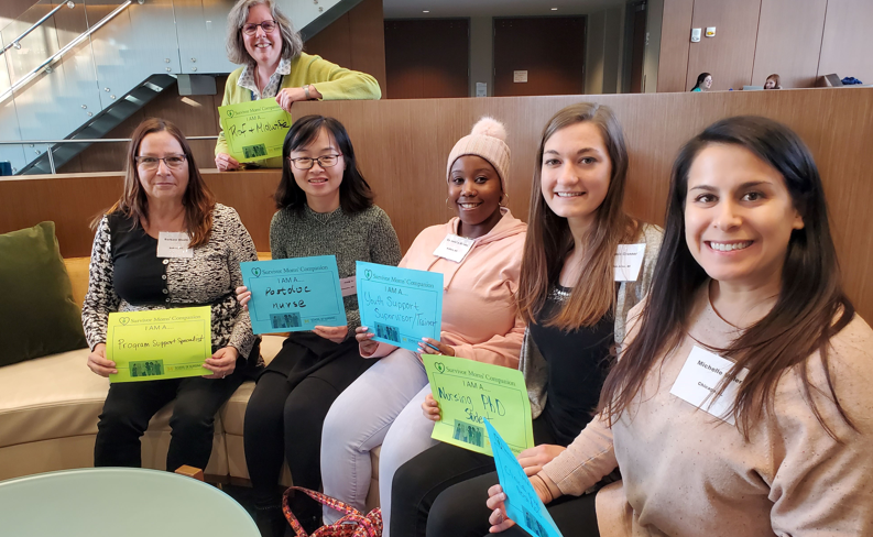 Students at a Hipp Event sitting together with signs