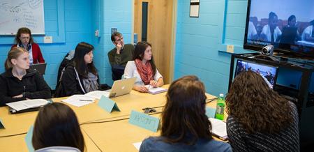 Matsumoto in an undergrad community health class during a video conference with nursing students in Haiti