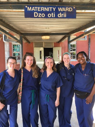 Sarah and group of students in scrubs outside of maternity ward 