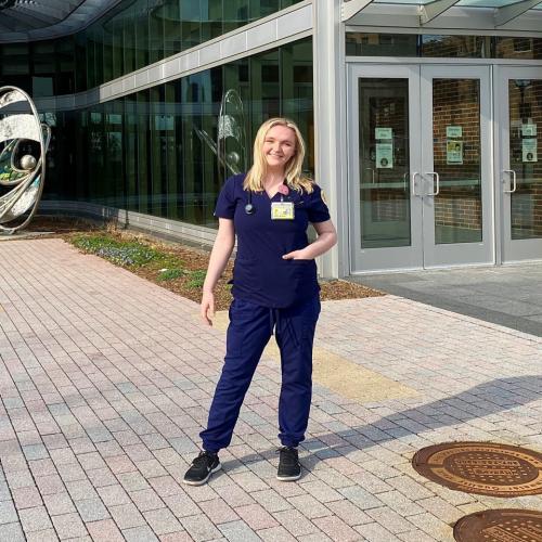  Emma Barr, BSN, RN in front of the Nursing School