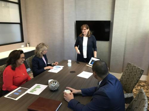  Molly James in front of a group of individals presenting an idea