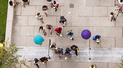 Overhead photo of student walking up to a building